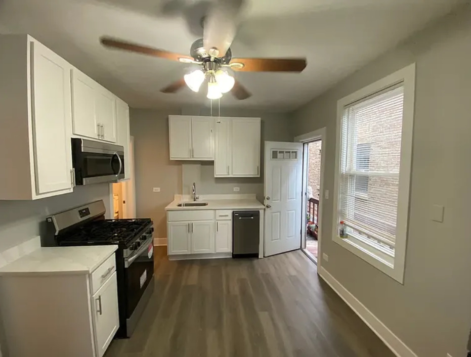 1019 West 18th Street Chicago, IL 60608 - Photo 14 of 26 a kitchen with a stove a sink and a refrigerator