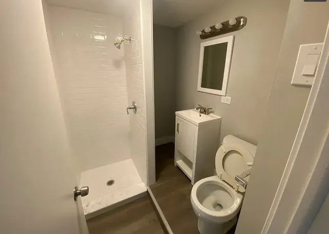a bathroom with a sink mirror toilet and shower