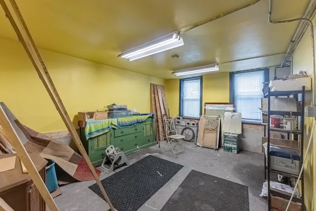 a room with lots of wooden furniture and a window