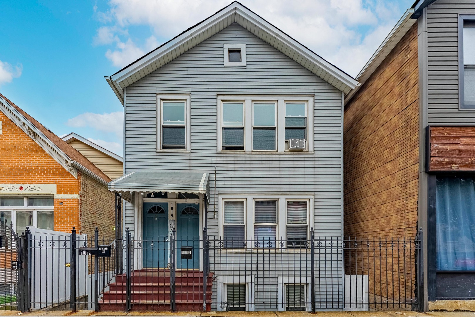 1019 West 18th Street Chicago, IL 60608 - Photo 2 of 26 a front view of a house with a garage