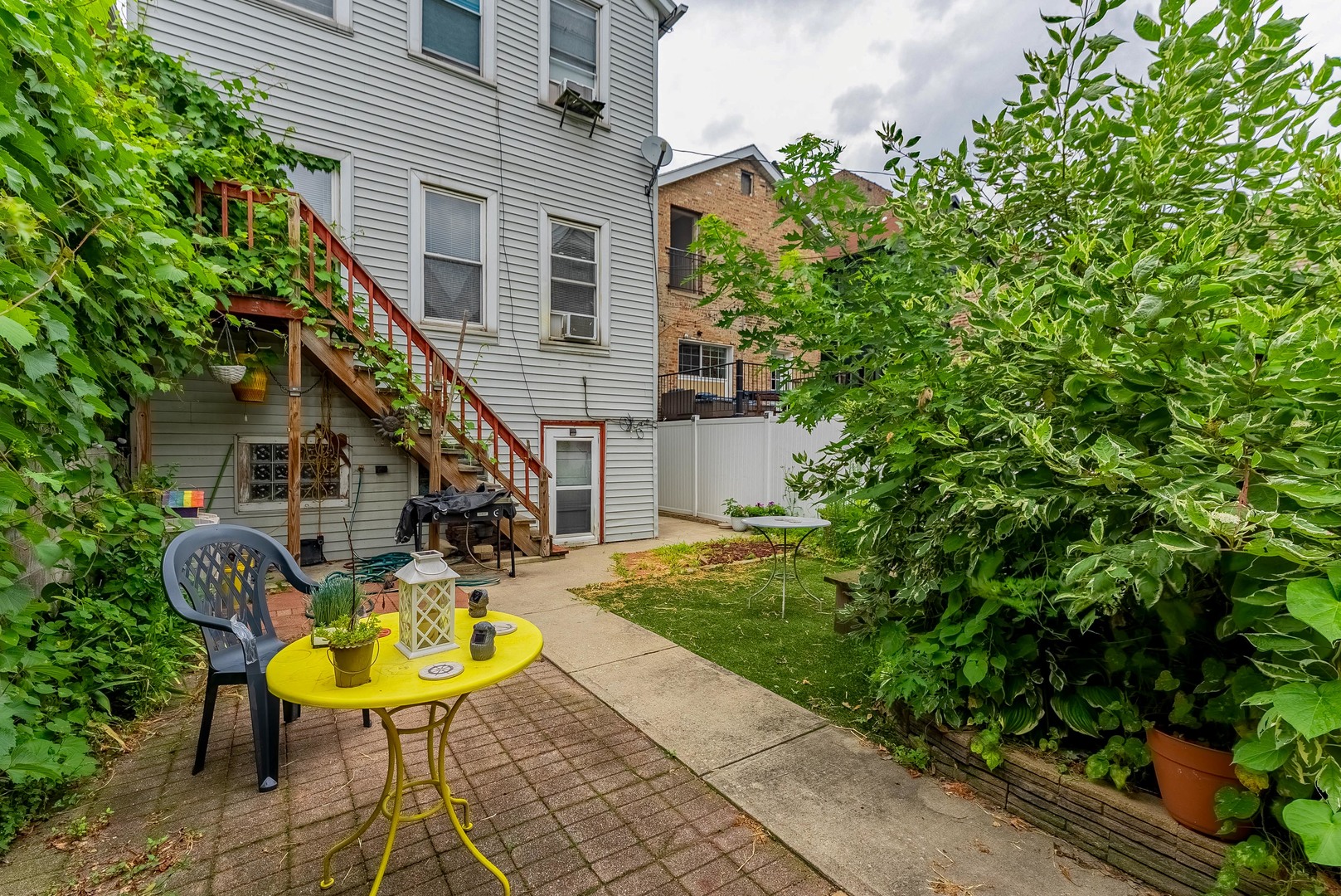 1019 West 18th Street Chicago, IL 60608 - Photo 26 of 26 a view of a house with backyard sitting area and garden