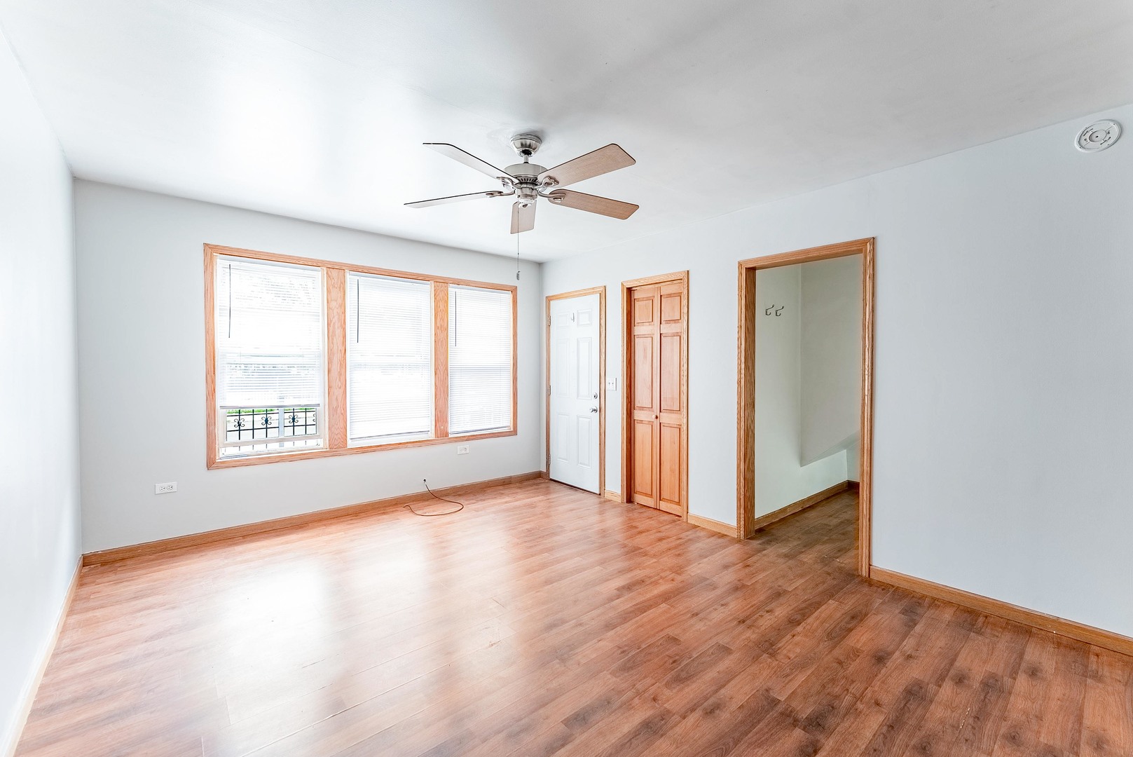 1019 West 18th Street Chicago, IL 60608 - Photo 3 of 26 a view of an empty room with a window and wooden floor