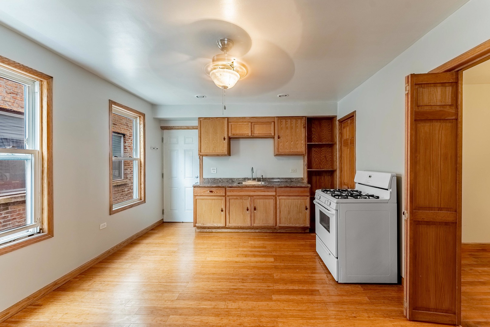 1019 West 18th Street Chicago, IL 60608 - Photo 5 of 26 a kitchen with a refrigerator stove and wooden floor