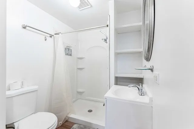 a bathroom with a sink toilet and shower