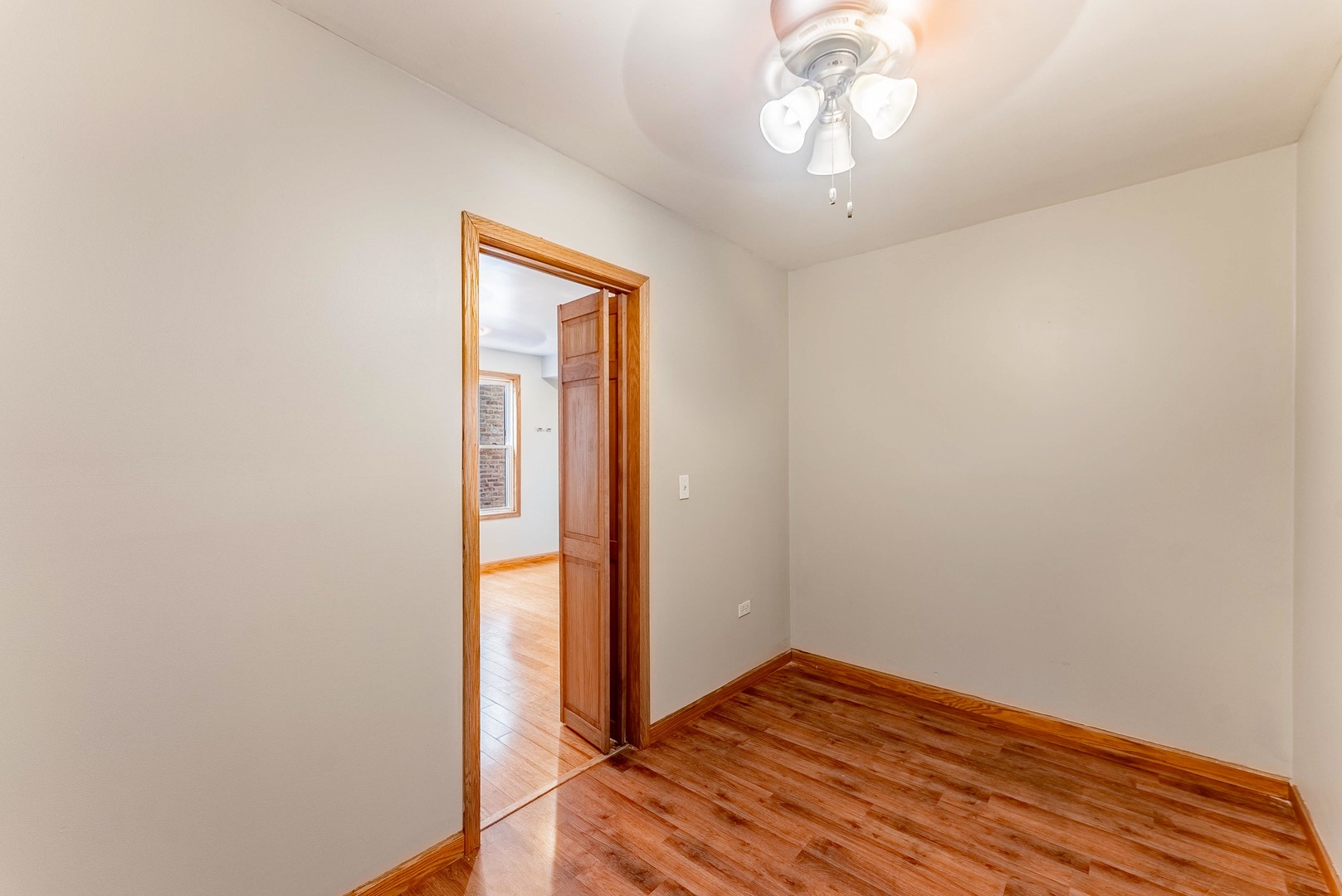 1019 West 18th Street Chicago, IL 60608 - Photo 9 of 26 a view of empty room with wooden floor and fan