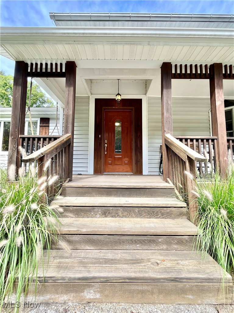 6543 North Ridge Road East Geneva, OH 44041 - Photo 3 of 49 View of exterior entry featuring a porch