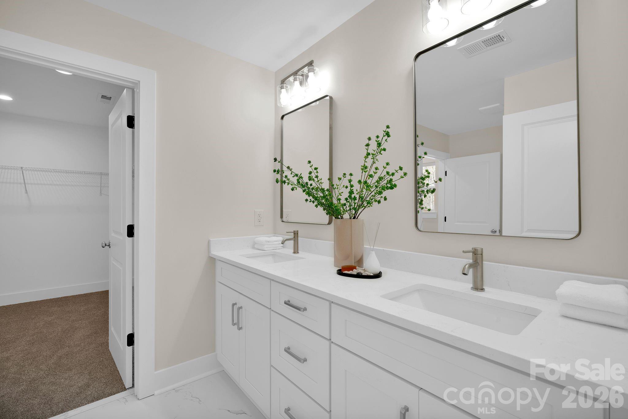 9052 Unity Church Road Mooresville, NC 28115 - Photo 17 of 32 a bathroom with double vanity sinks and a mirror