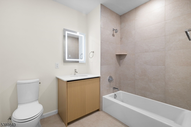 70 Ridgedale Avenue, Unit 207 Morristown, NJ 07960 - Photo 17 of 21 a bathroom with a sink a toilet and shower