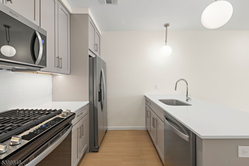 70 Ridgedale Avenue, Unit 207 Morristown, NJ 07960 - Photo 4 of 21 a kitchen with stainless steel appliances granite countertop a sink and a stove