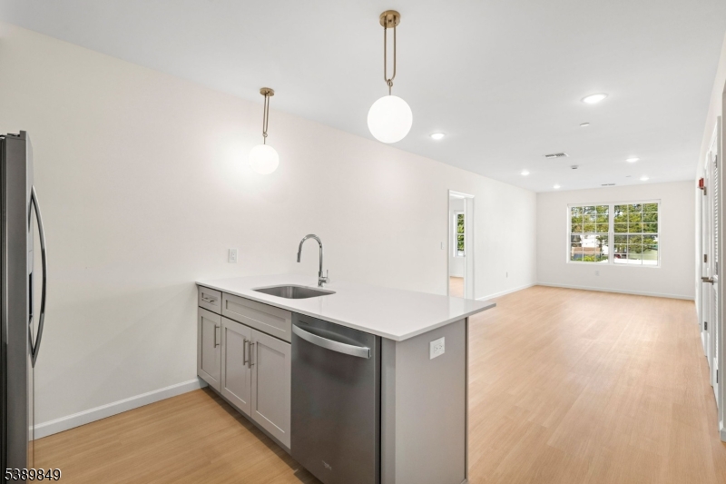 70 Ridgedale Avenue, Unit 207 Morristown, NJ 07960 - Photo 5 of 21 a kitchen with stainless steel appliances granite countertop a sink a window and a refrigerator