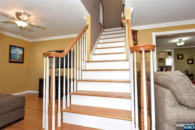 a view of a livingroom with a ceiling fan and couch