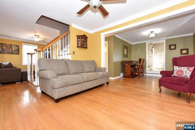 a living room with furniture and a dining table