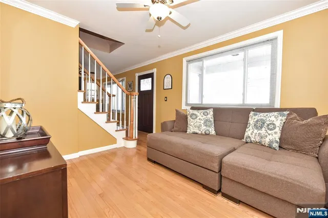 a living room with furniture and a chandelier