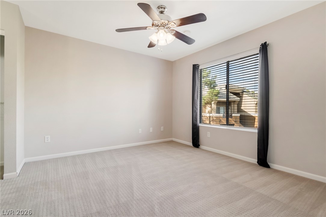 8070 West Russell Road, Unit 2006 Las Vegas, NV 89113 - Photo 21 of 24 A well-lit bedroom with soft carpet, offering comfortable living and ample natural light.