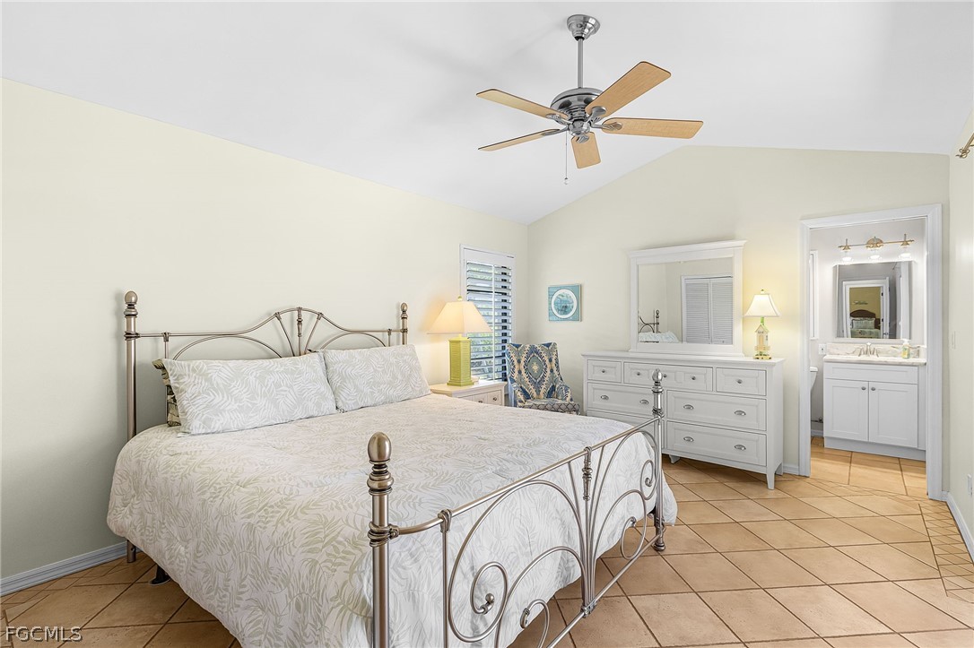 7747 Grande Pine Road Bokeelia, FL 33922 - Photo 27 of 45 a bedroom with a bed and a chandelier
