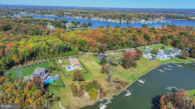an aerial view of a house with a lake view