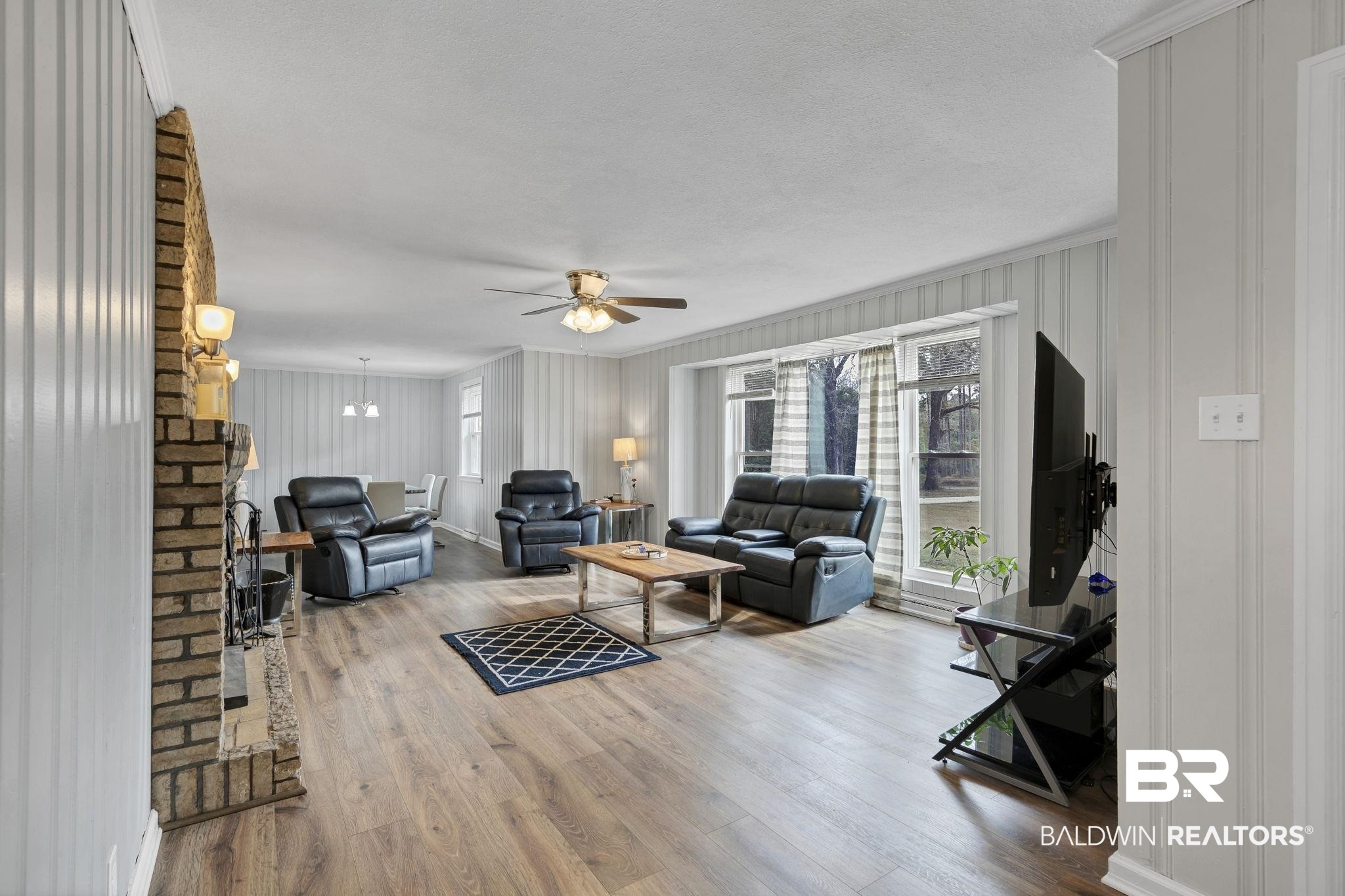 4690 Lott Road Eight Mile, AL 36613 - Photo 13 of 45 Living room with hardwood / wood-style floors, crown molding, a textured ceiling, and ceiling fan