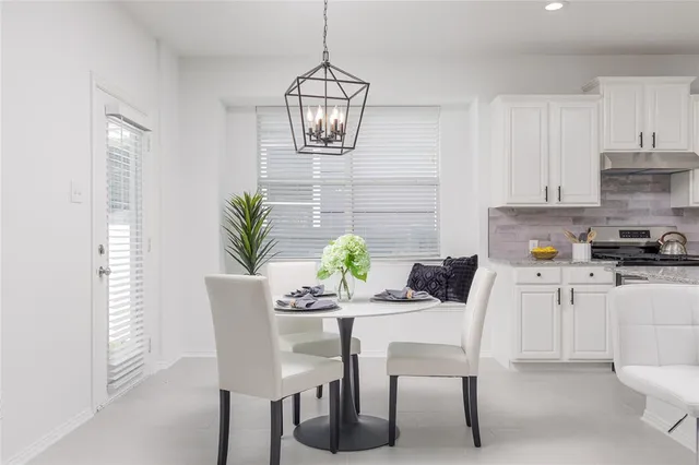 a dining room with furniture and window