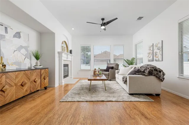 a living room with furniture and wooden floor
