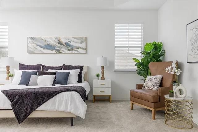 a spacious bedroom with a bed and a couch