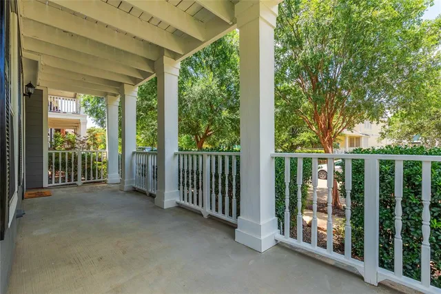 a view of a balcony with floor to ceiling window and wooden fence