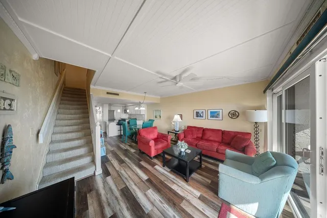 a large bedroom with a large bed and a flat tv screen on dresser