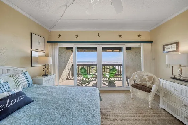 a balcony with table and chairs