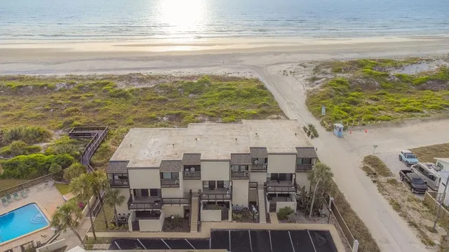 a view of a swimming pool with outdoor seating and plants