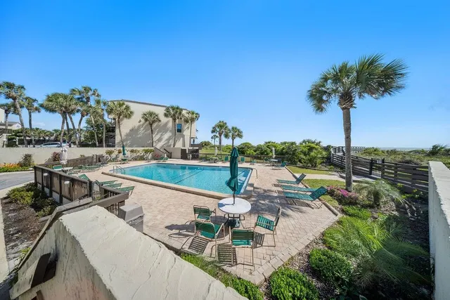 a view of swimming pool with outdoor seating and plants
