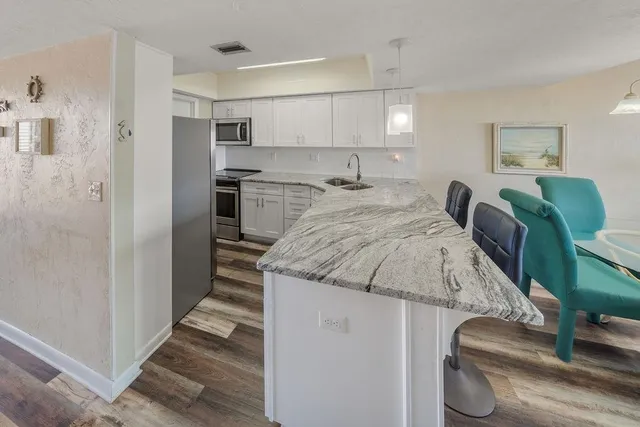 a kitchen with a refrigerator sink and microwave