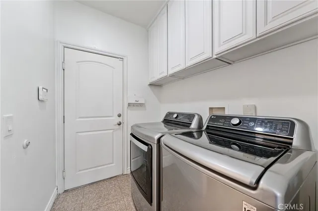 a view of kitchen stove and white cabinets