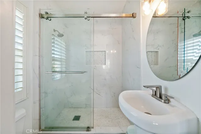 a bathroom with a shower and a sink