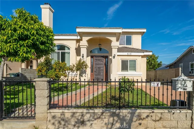 a front view of a house with a garden