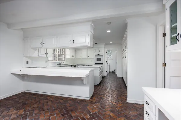 a kitchen with a stove sink and microwave