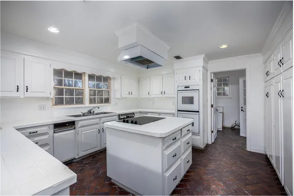 a kitchen with a sink stove and cabinets