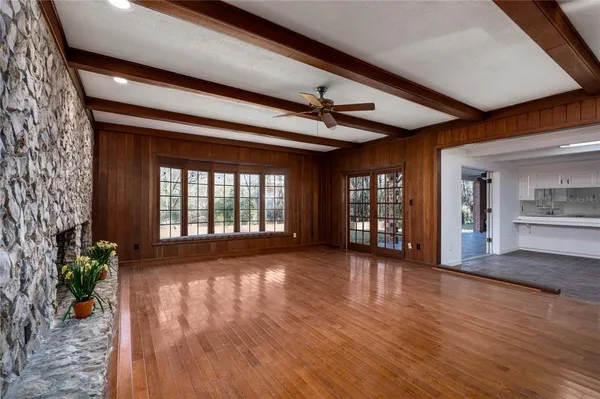 a view of a livingroom with fireplace and wooden floor