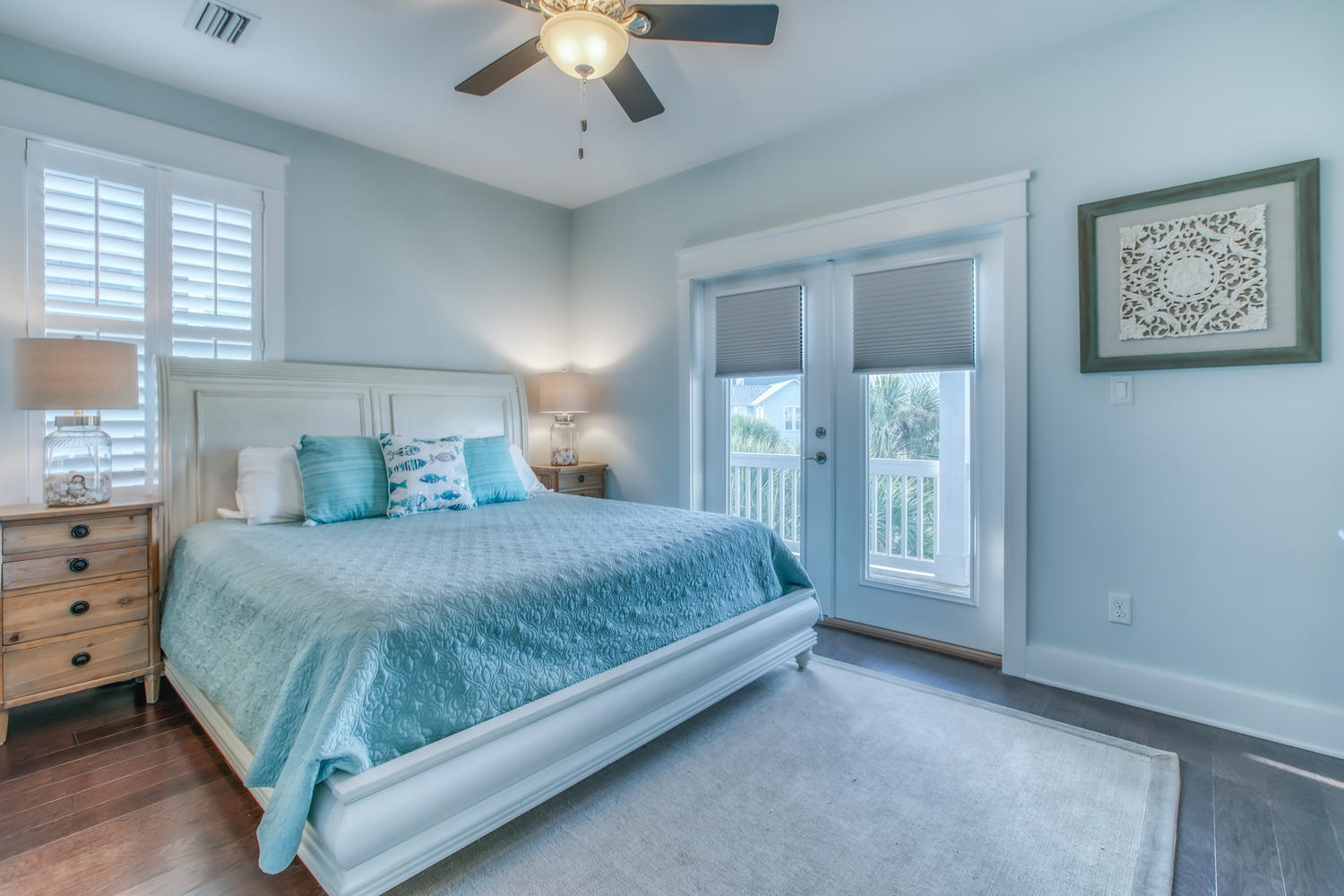 105 Lifeguard Loop West Inlet Beach, FL 32461 - Photo 24 of 45 a bedroom with a large bed and a chandelier