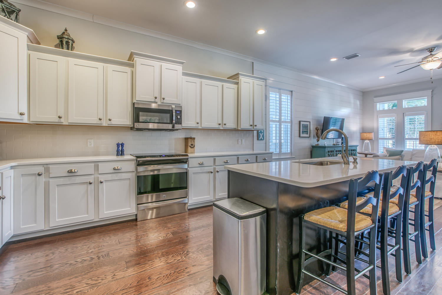 105 Lifeguard Loop West Inlet Beach, FL 32461 - Photo 10 of 45 a kitchen with granite countertop wooden floors white cabinets and appliances