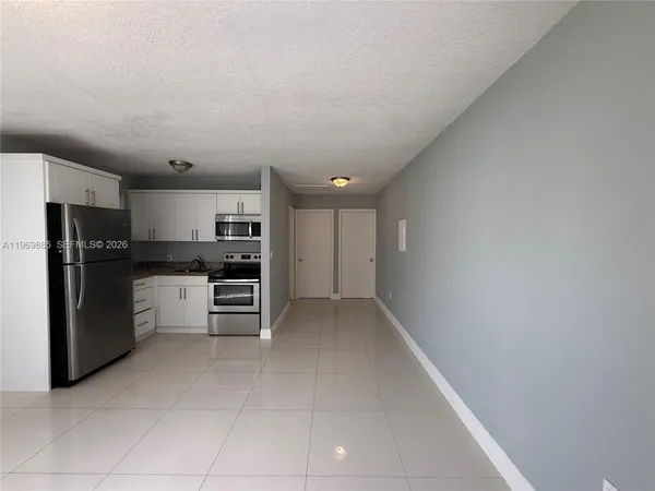 a kitchen with stainless steel appliances a refrigerator and cabinets