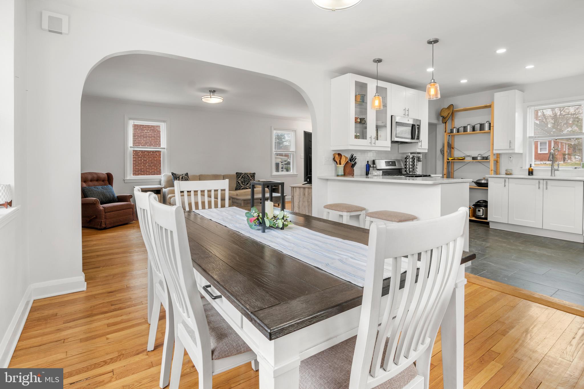 4823 Herring Run Drive Baltimore, MD 21214 - Photo 15 of 34 a large white kitchen with kitchen island a large counter top appliances and cabinets