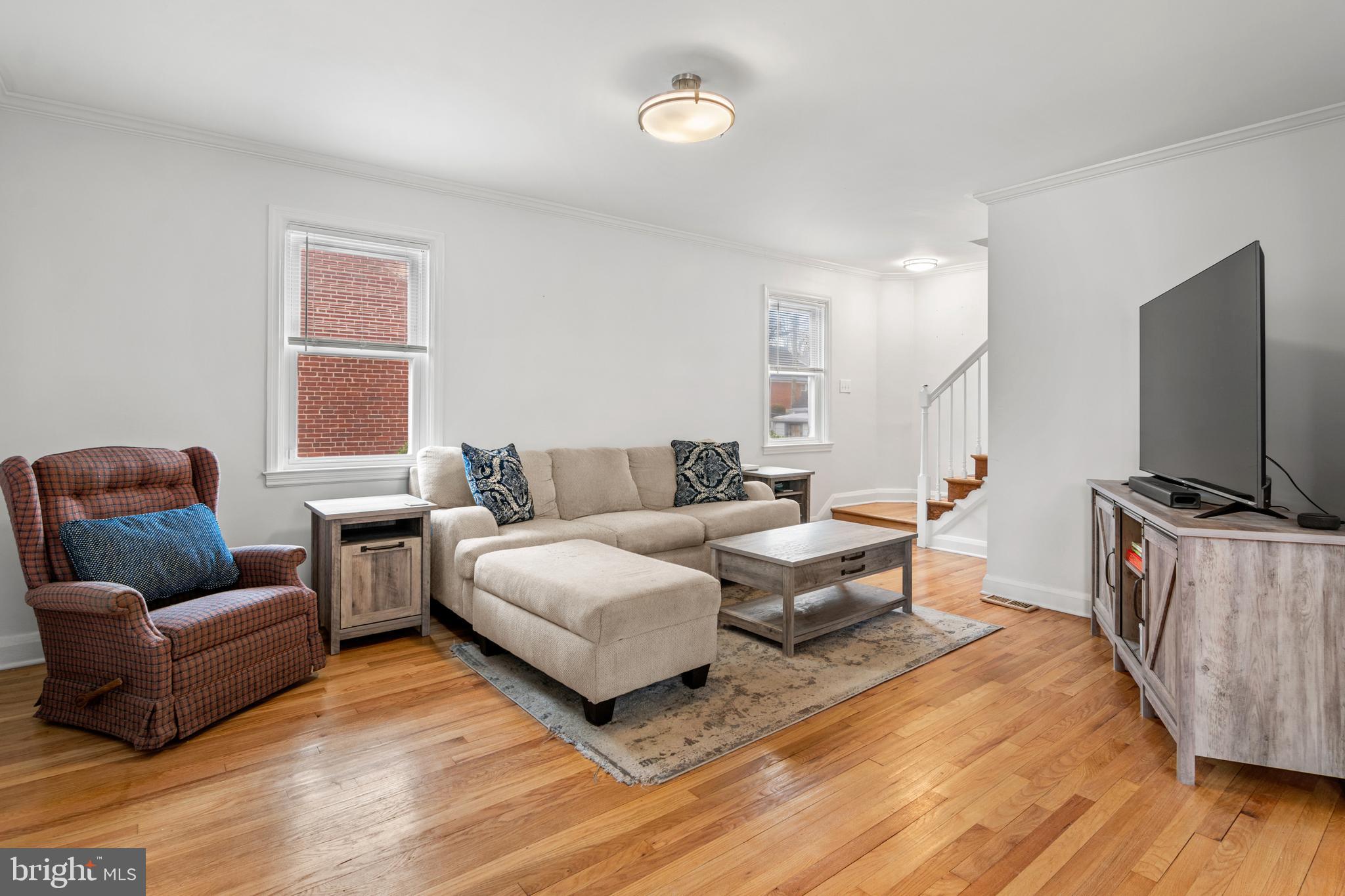 4823 Herring Run Drive Baltimore, MD 21214 - Photo 20 of 34 a living room with furniture flat screen tv and wooden floor
