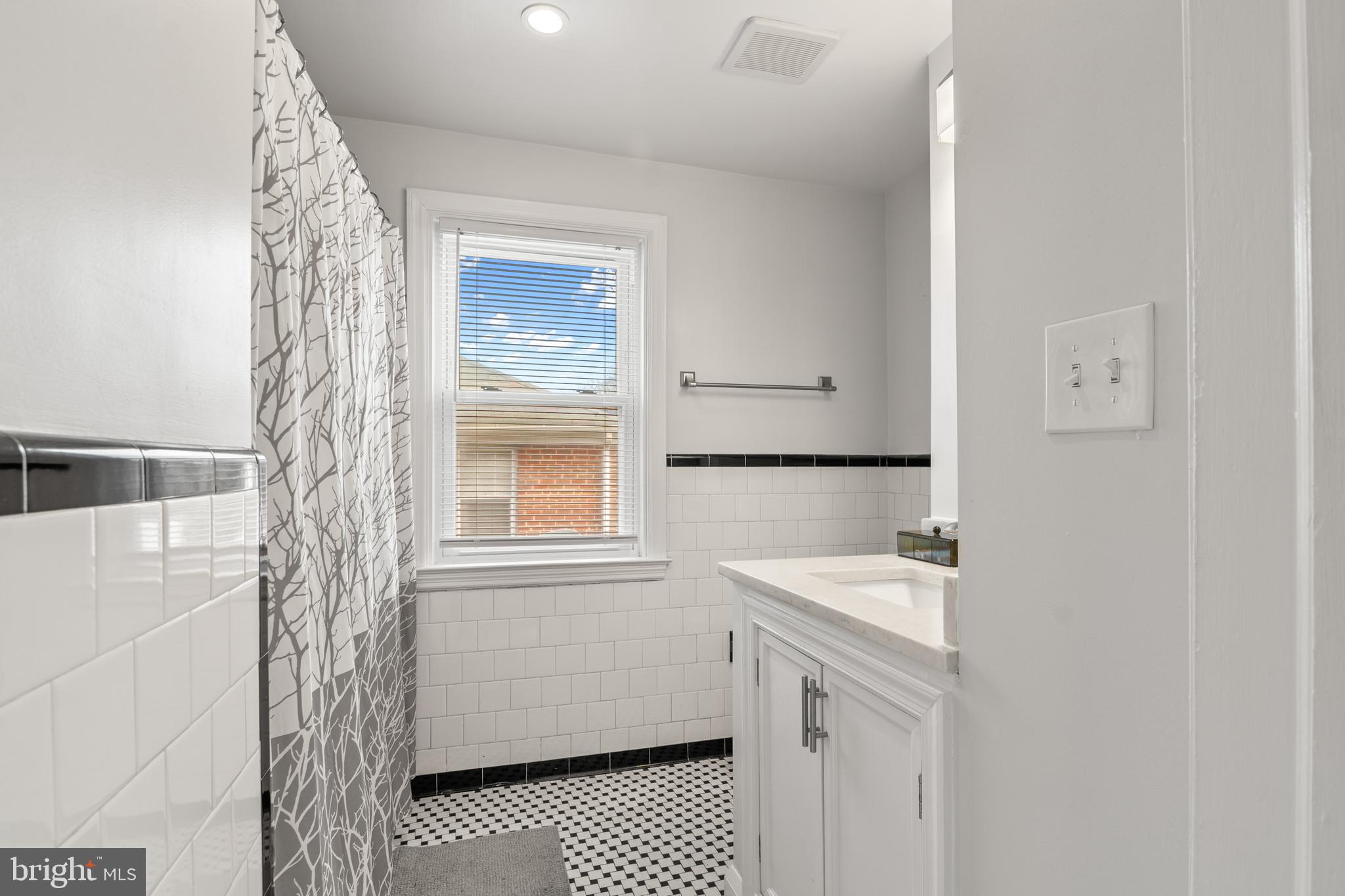 4823 Herring Run Drive Baltimore, MD 21214 - Photo 21 of 34 a bathroom with a sink a toilet and shower