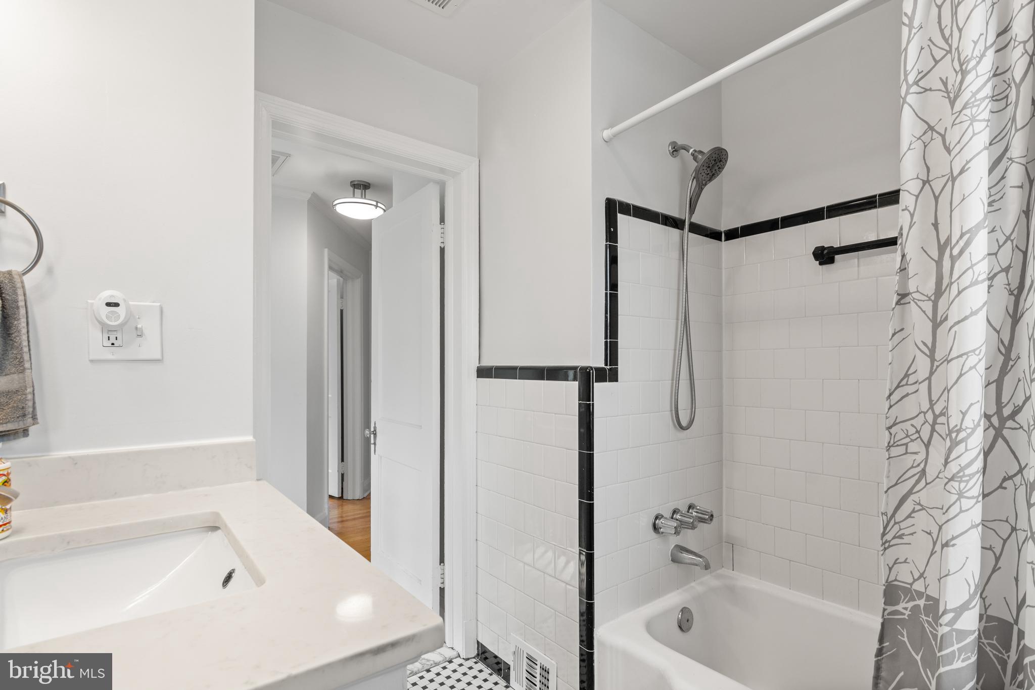 4823 Herring Run Drive Baltimore, MD 21214 - Photo 23 of 34 a bathroom with a bathtub and a shower