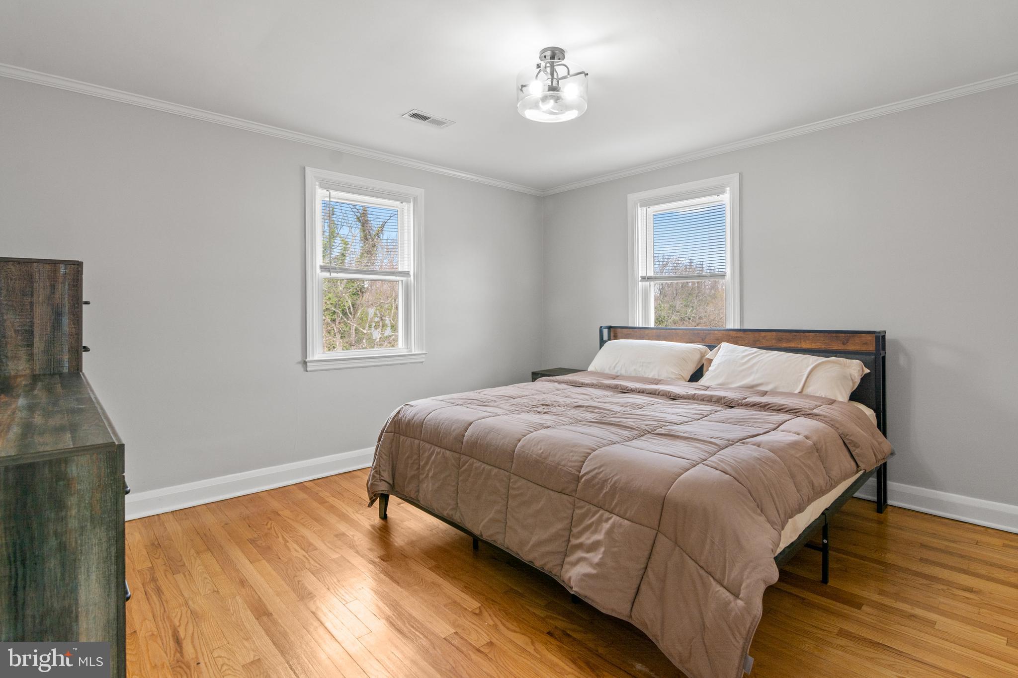 4823 Herring Run Drive Baltimore, MD 21214 - Photo 24 of 34 a bedroom with a bed and wooden floor