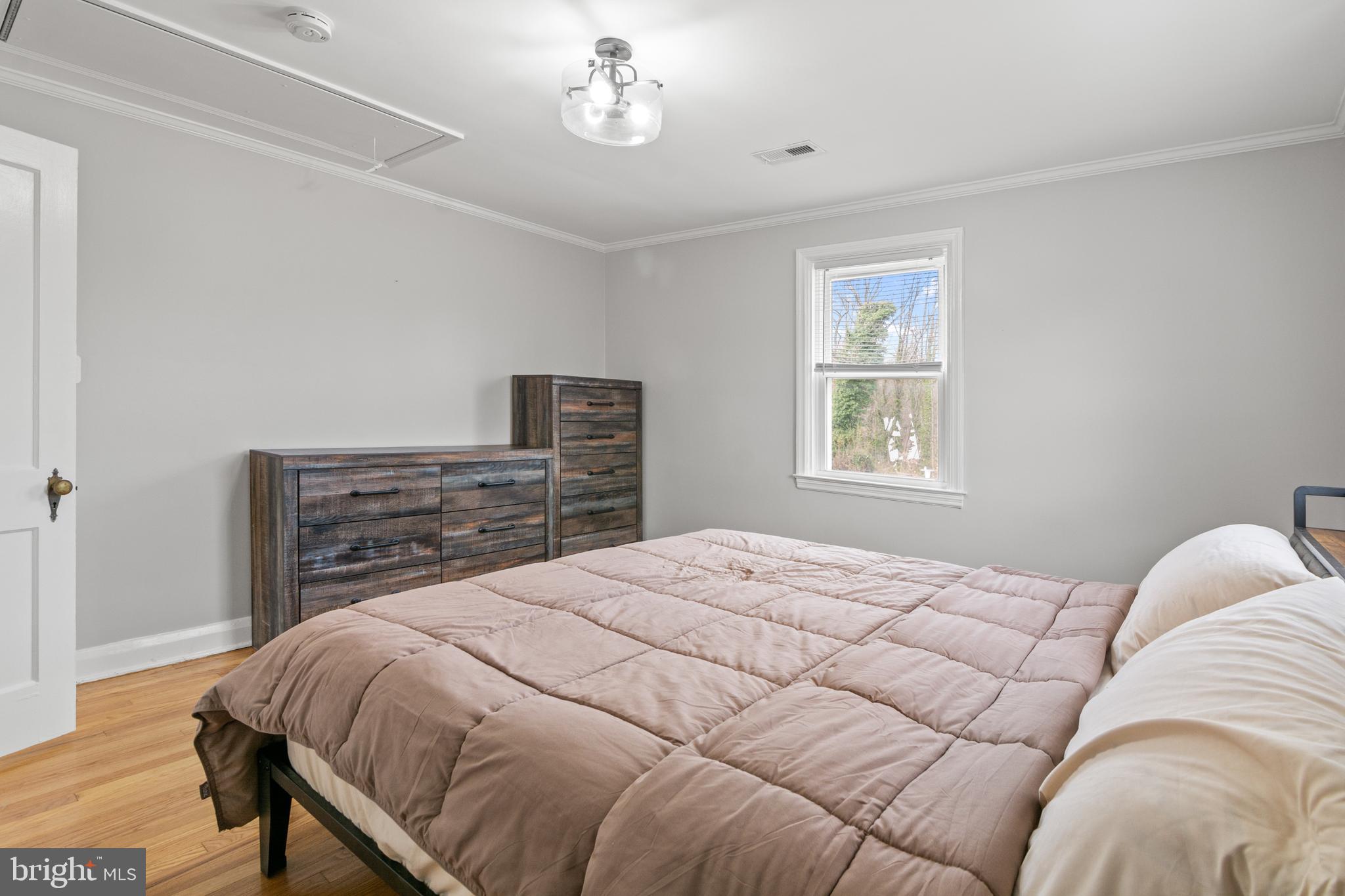 4823 Herring Run Drive Baltimore, MD 21214 - Photo 25 of 34 a bedroom with a bed and dresser