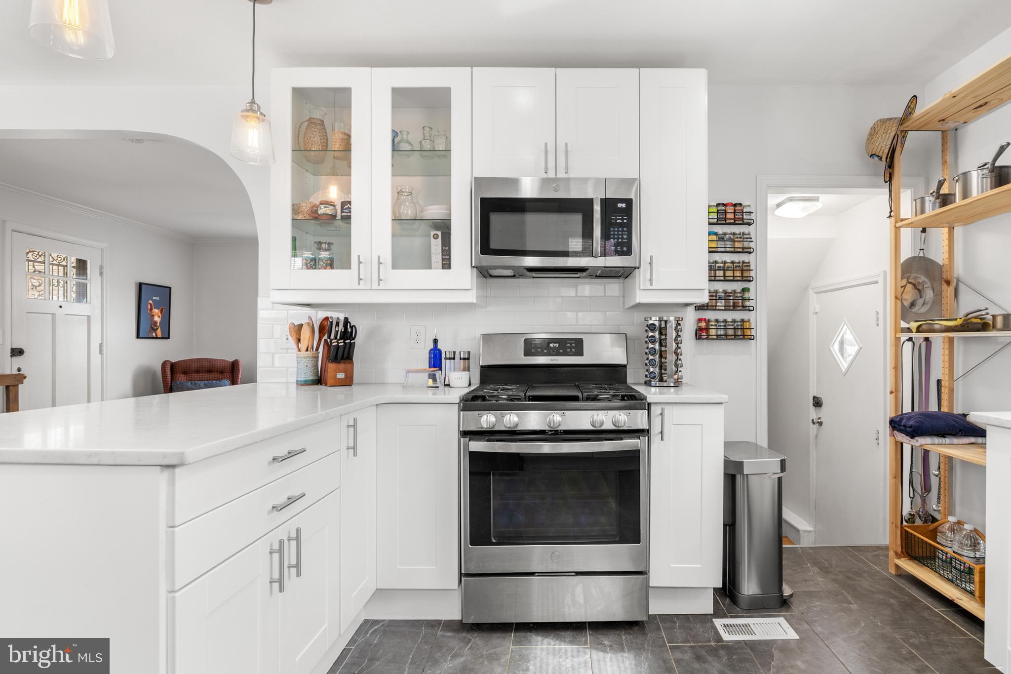 4823 Herring Run Drive Baltimore, MD 21214 - Photo 3 of 34 a kitchen with cabinets stainless steel appliances and a sink