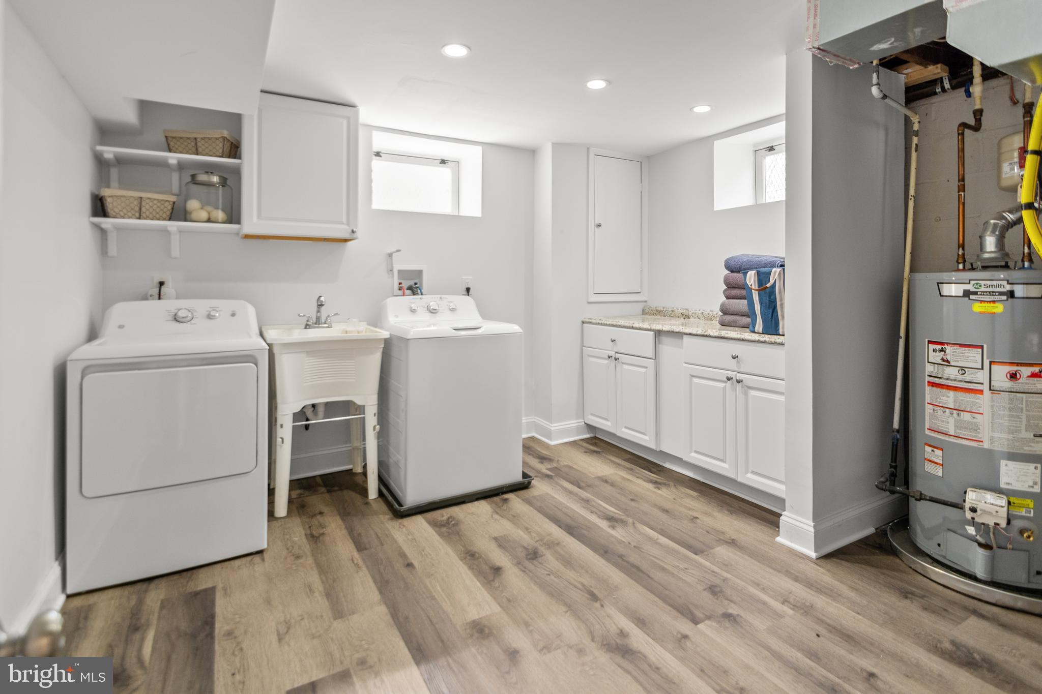 4823 Herring Run Drive Baltimore, MD 21214 - Photo 31 of 34 a utility room with cabinets washer and dryer