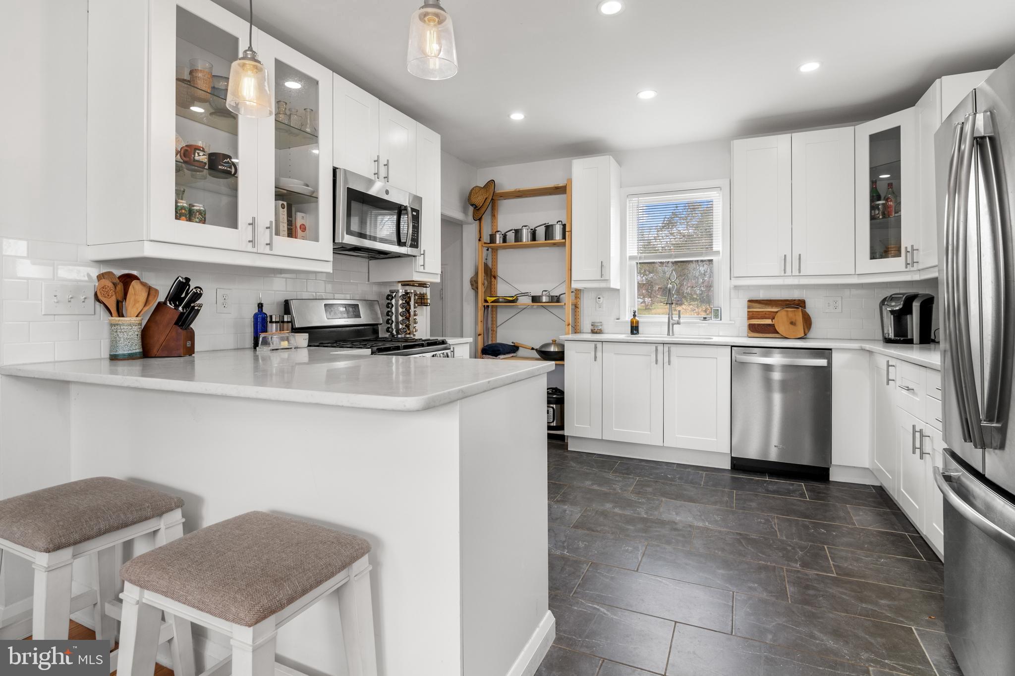 4823 Herring Run Drive Baltimore, MD 21214 - Photo 7 of 34 a kitchen with stainless steel appliances granite countertop a sink and cabinets