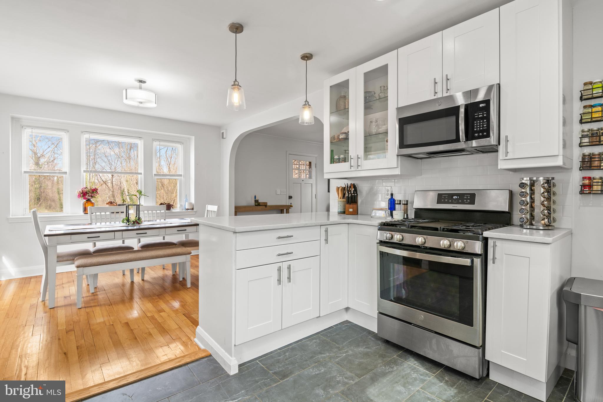 4823 Herring Run Drive Baltimore, MD 21214 - Photo 8 of 34 a kitchen with stainless steel appliances granite countertop a stove a sink and a microwave