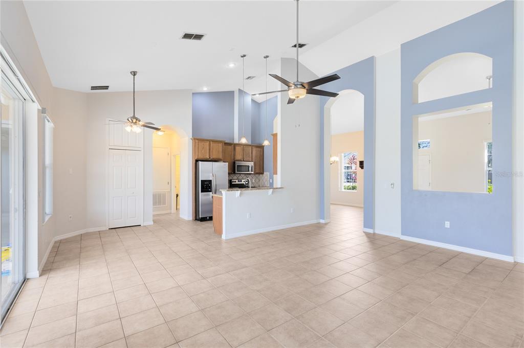 3510 Pawleys Loop South St. Cloud, FL 34769 - Photo 11 of 32 a view of a kitchen with a refrigerator and a stove top oven